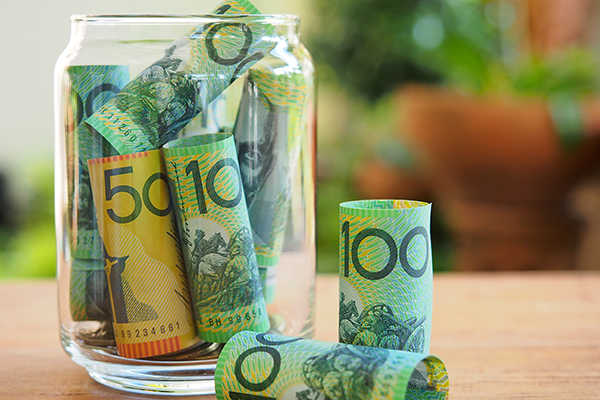 Australia bank note in glass jar for save money concept - Halo Financial