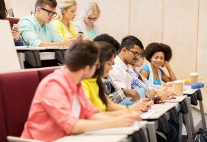 group of students with coffee writing on lecture. Education in USA concept