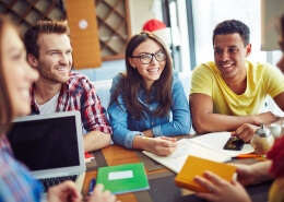 Group of Smiling students talking to each other symbolising student exchange