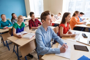 group of students with notebooks at school lesson symbolising education in Canada