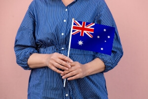 Australia flag. Close up of a woman's hands holding Australian flag.