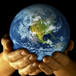2 hands holding the world globe. Moving abroad alone concept.