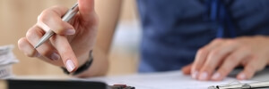 Close up of female accountant or banker making calculations. Savings, finances and economy 