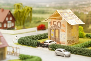 a euro bill house in a green neighbourhood scenery when buying a property abroad