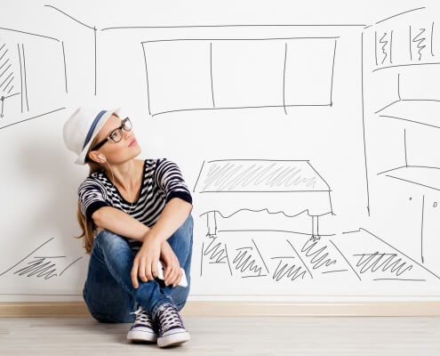 Dreaming woman in headset over drawn living room background Concept to real estate investment