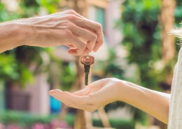 Real estate agent giving keys to apartment owner, buying selling property business. Close up of male hand taking house key from realtor. Mortgage for purchasing flat, getting access to own home after a real estate investment