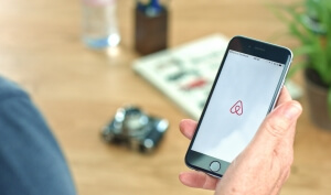 Apple iPhone. Showing Airbnb application on the screen. Airbnb is a website for people to list, find, and rent lodging.