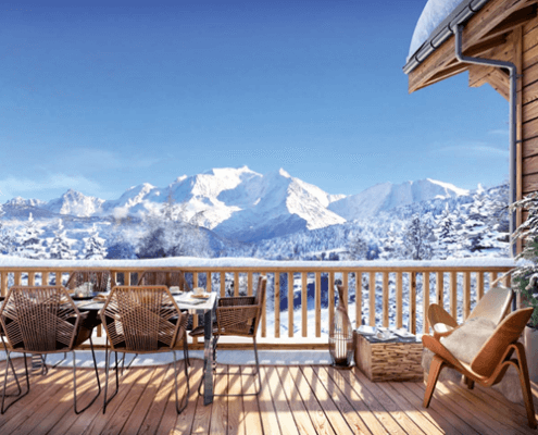A house in the middle of the snow with a beautiful view of a mountain