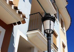 White apartments with balcony and blue sky. Concept of property abroad