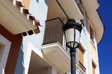 White apartments with balcony and blue sky. Concept of property abroad