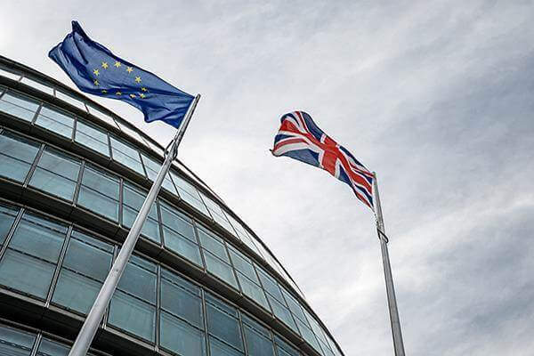 Looking up at EU and UK flags outside City Hall, London