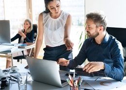 Three-business-people-in-the-office-working-together-corporate-clients