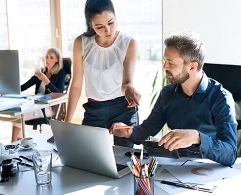 Three-business-people-in-the-office-working-together-corporate-clients