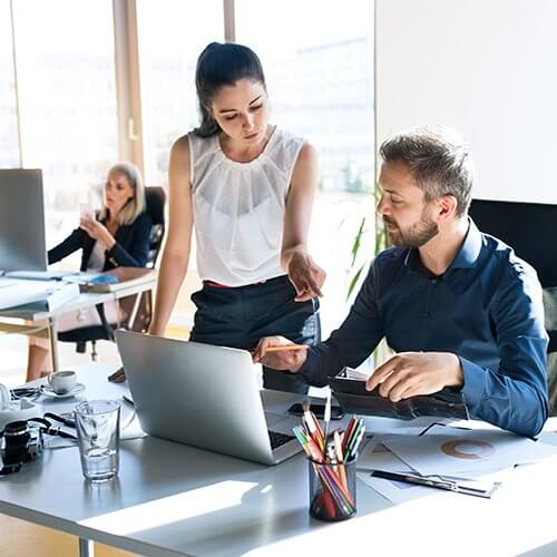 Three-business-people-in-the-office-working-together-corporate-clients