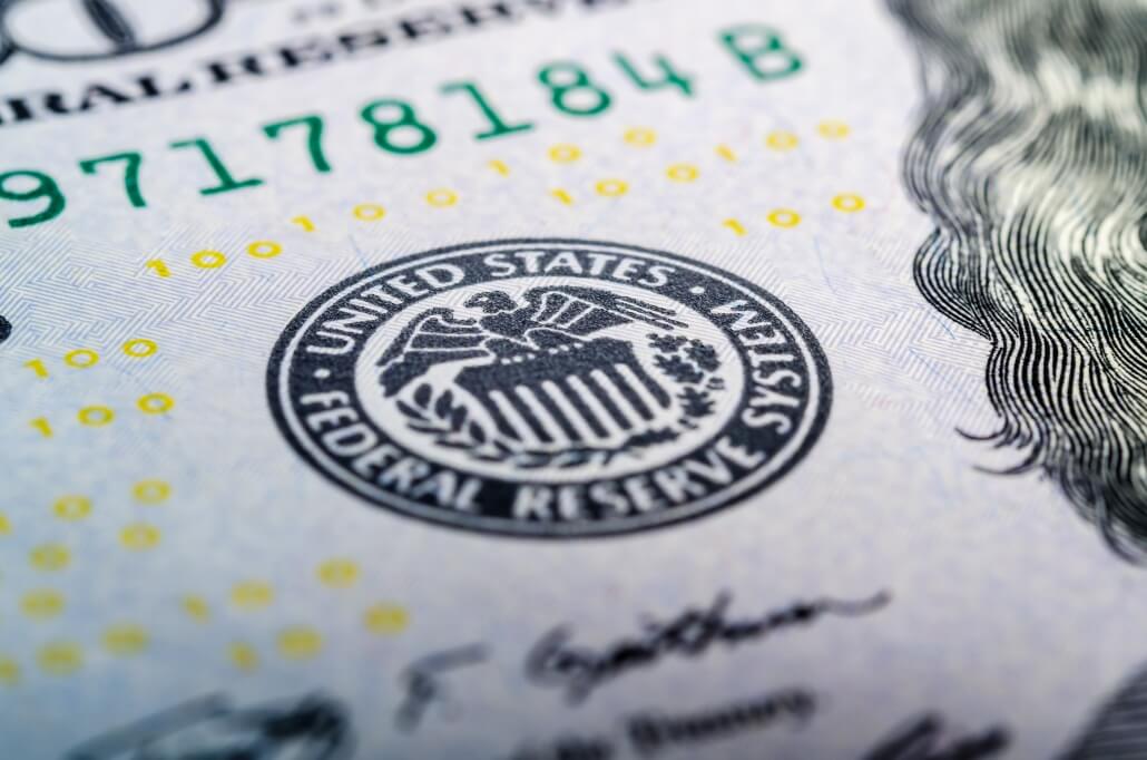 Federal reserve system symbol on hundred dollar bill closeup. US central bank