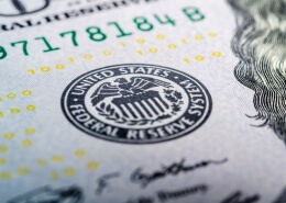 Federal reserve system symbol on hundred dollar bill closeup. US central bank