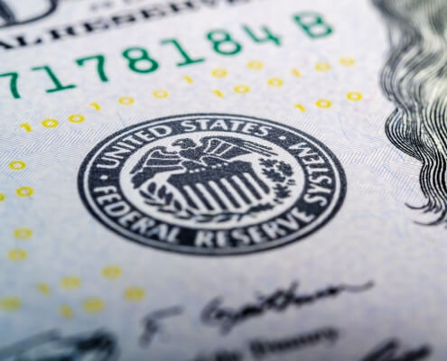Federal reserve system symbol on hundred dollar bill closeup. US central bank