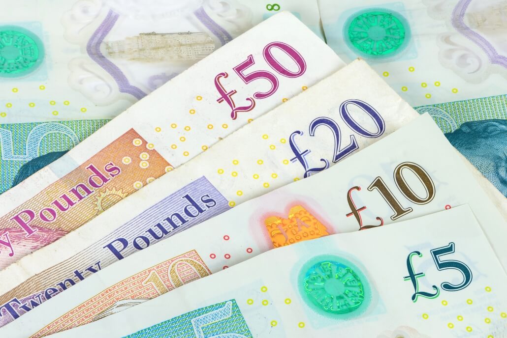 Set of english pounds banknotes. Sterling calm despite UK employment data