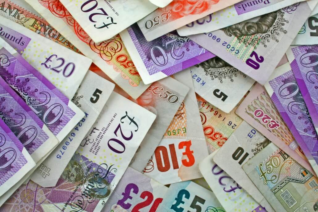 pile sterling notes sprawled out symbolising Sterling and UK economy
