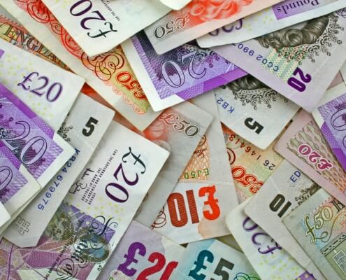 pile sterling notes sprawled out symbolising Sterling and UK economy