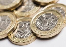 New one pound sterling British sterling coin. Sterling reaction to UK employment data