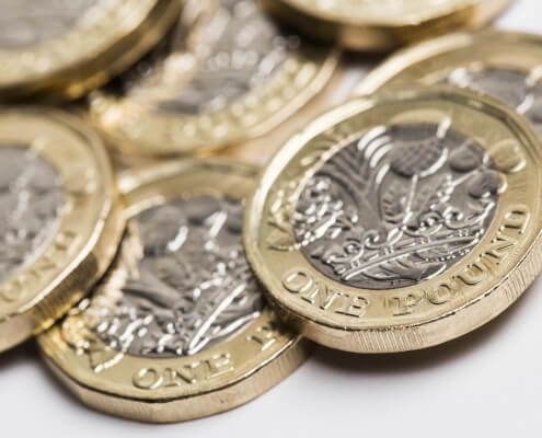 New one pound sterling British sterling coin. Sterling reaction to UK employment data