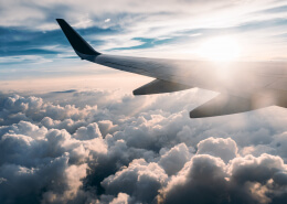 clouds and airplane wings in sky