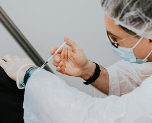 man injecting vaccine