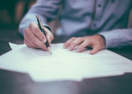 man signing the global tax deal