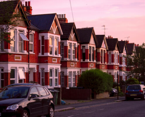 cars on street in front of London houses