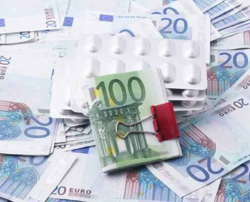 British pound and euro currency notes with medicine pack