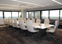 empty board room with white chairs and table
