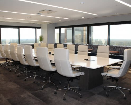 empty board room with white chairs and table
