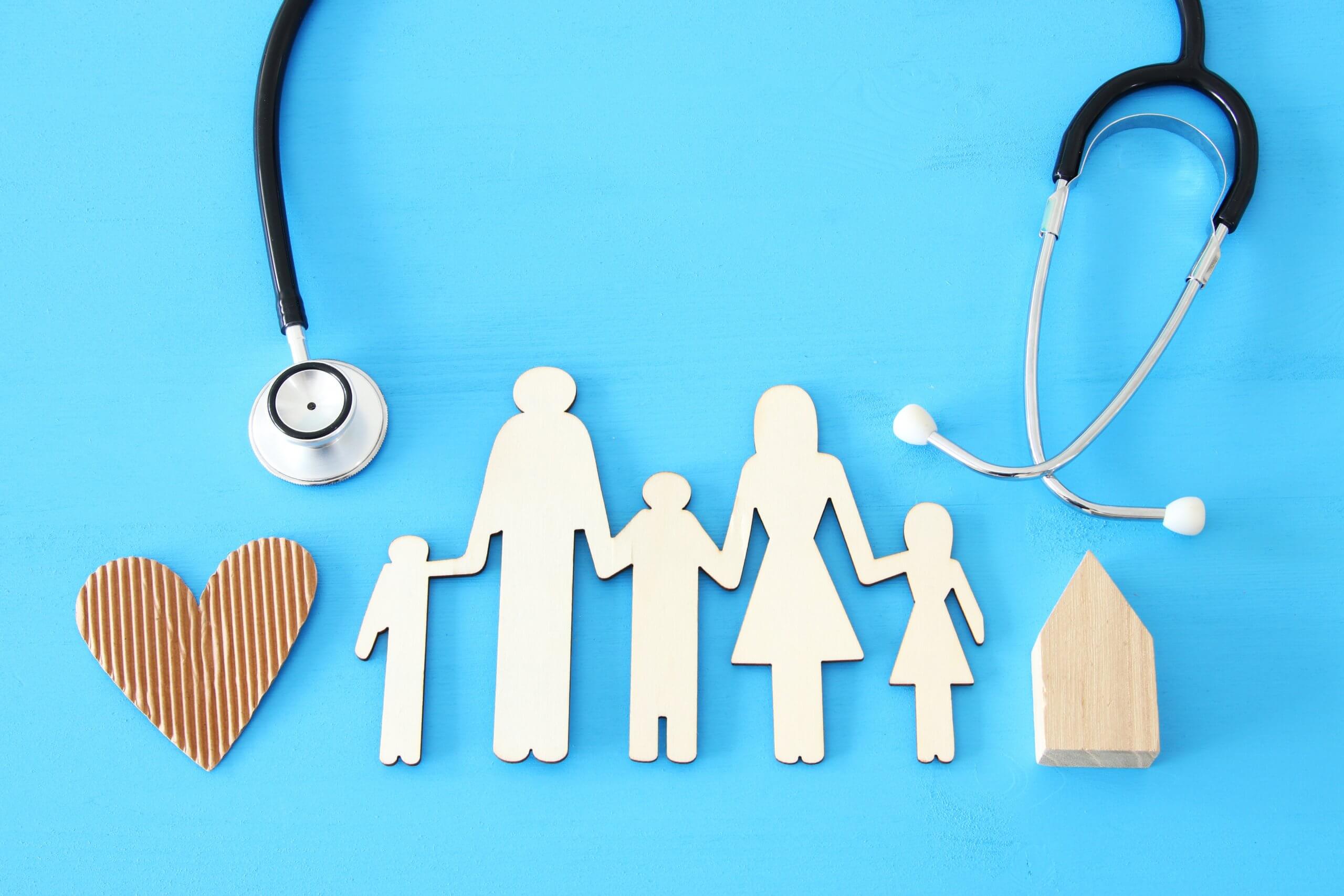 Health Insurance . concept image of Stethoscope and family on wooden table. top view