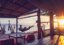 man with in a hammock with a laptop