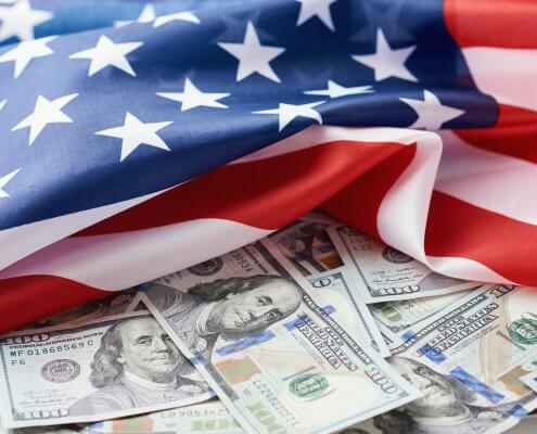 USA national flag and the dollar bills. Business and finance concept