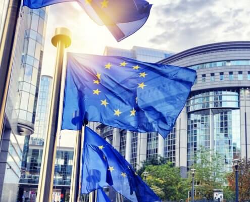 EU flags waving in front of European Parliament building in Brus