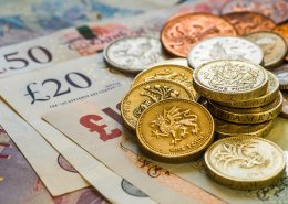 British coins stack on pound sterling notes