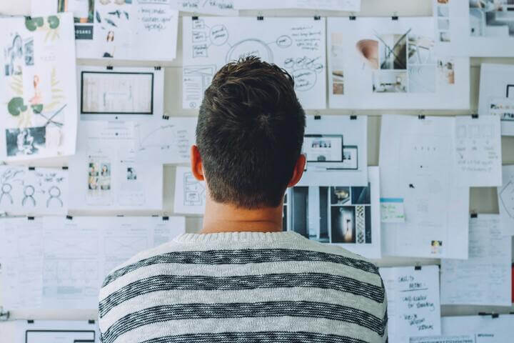 man looking at the diagrams on wall