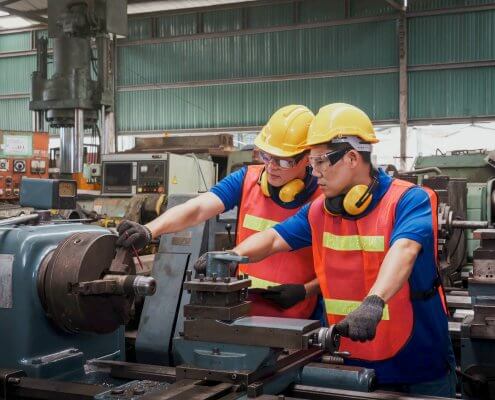 mechanical engineers working with yellow safety helmet