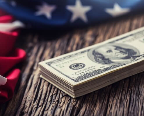 close view of american dollar cash and usa flag