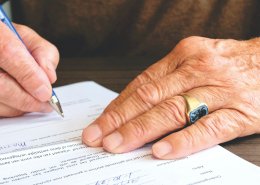 a man signing on bank account opening form