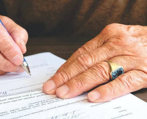 a man signing on bank account opening form