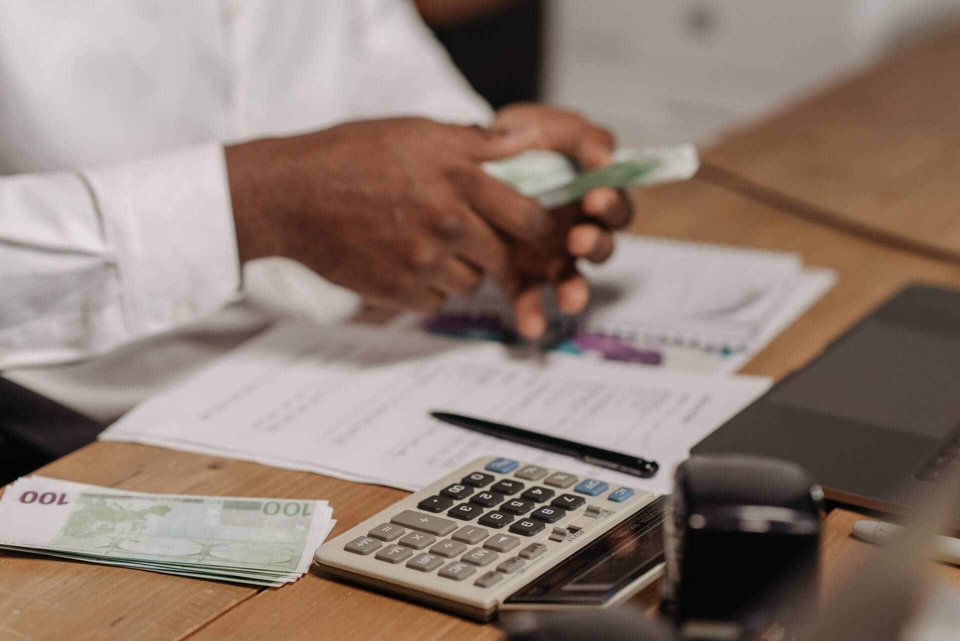 man holding notes for money transfer