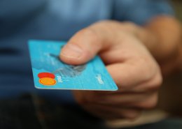 man giving debit card for payment