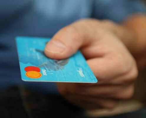 man giving debit card for payment