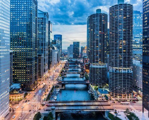 a scenic view of a river flowing through skyscrapers