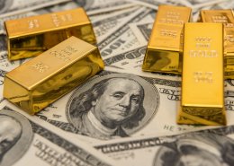 gold bullion bars on usd money bills