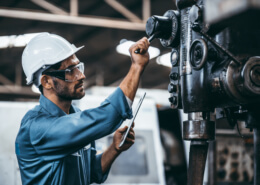 Engineer working at industrial machinery