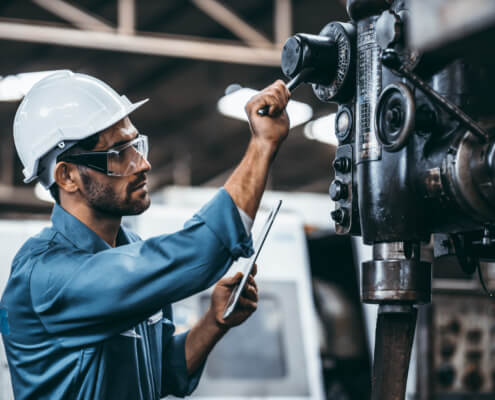 Engineer working at industrial machinery